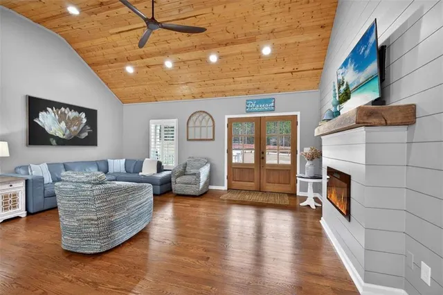 a kitchen with stainless steel appliances kitchen island granite countertop a table chairs sink and cabinets