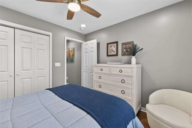 a bathroom with a granite countertop sink a toilet and a mirror