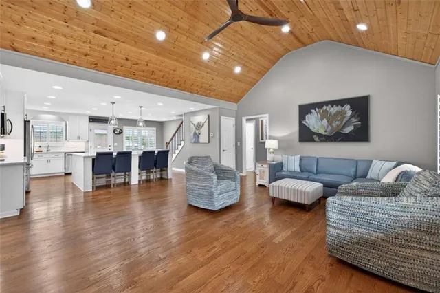 a living room with fireplace furniture and a wooden floor