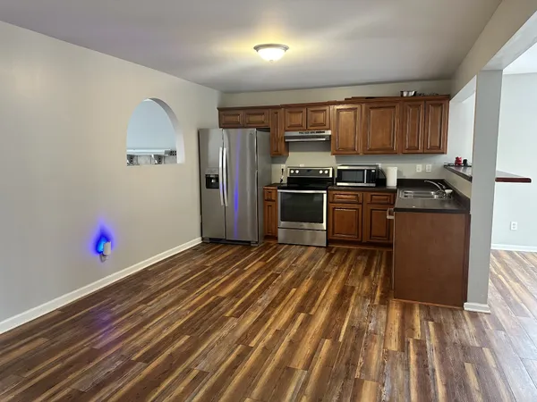 a kitchen with granite countertop stainless steel appliances and wooden cabinets