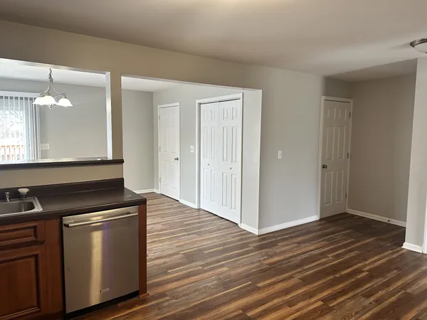 a kitchen with granite countertop a stove and a wooden floor