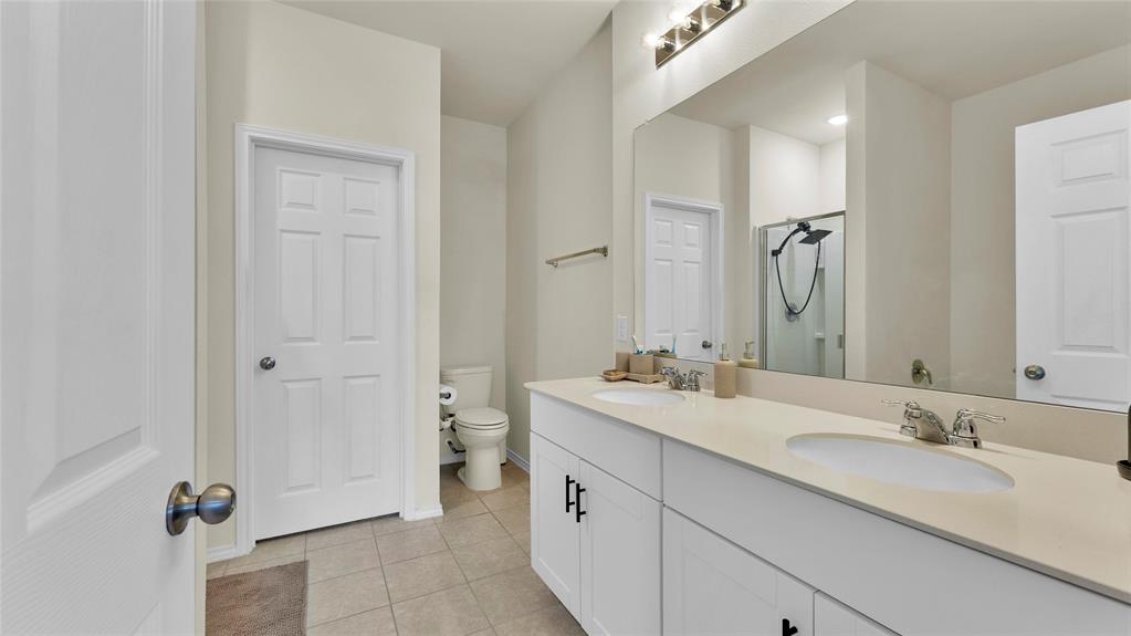 707 Indigo Road Princeton, TX 75407 - Photo 18 of 29 Dual vanity with undermount sinks and light-toned countertops