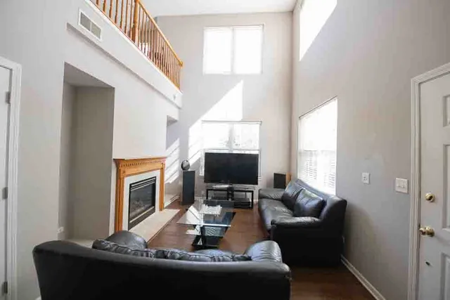 a view of a livingroom with furniture hardwood floor and staircase