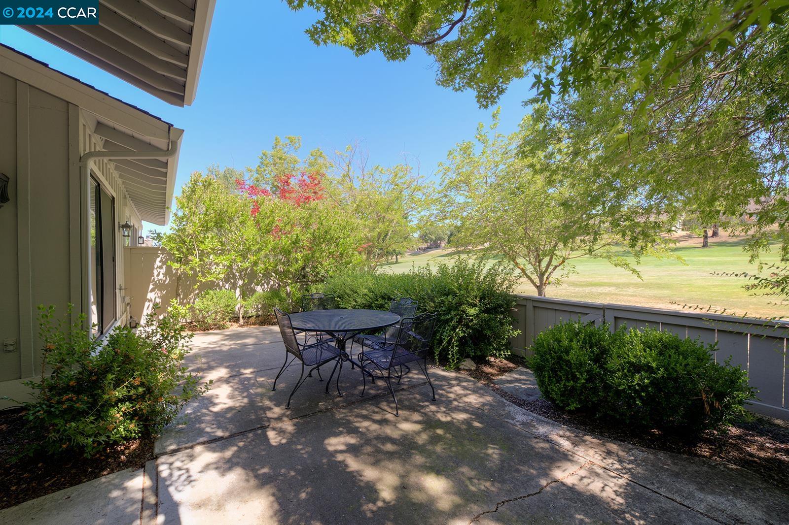 564 Cambrian Way Danville, CA 94526 - Photo 10 of 13 a backyard of a house with table and chairs plants and large trees