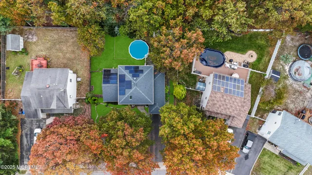 aerial view of a house with yard space and street view