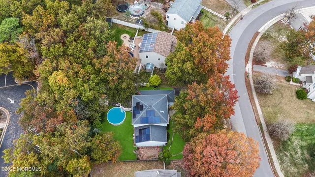 an aerial view of a house with a swimming pool
