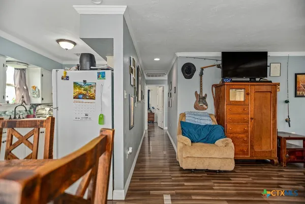 a bedroom with a bed and a flat tv screen on dresser