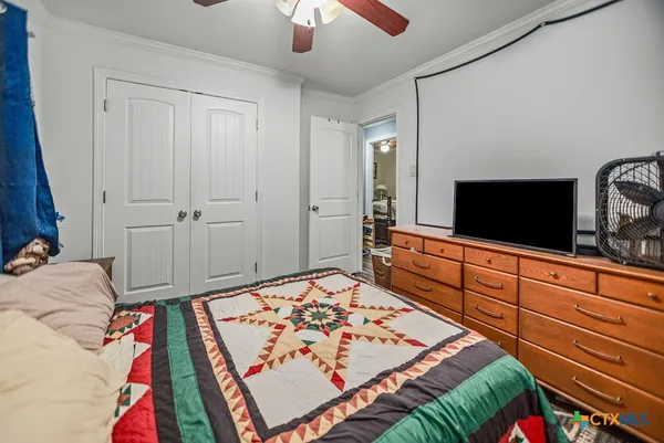 a bedroom with a bed and a chandelier