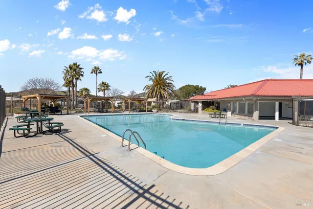 a swimming pool with outdoor seating and yard