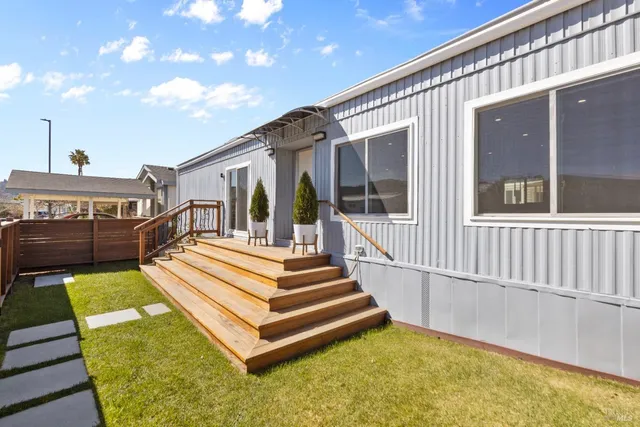 a view of a house with pool and wooden deck