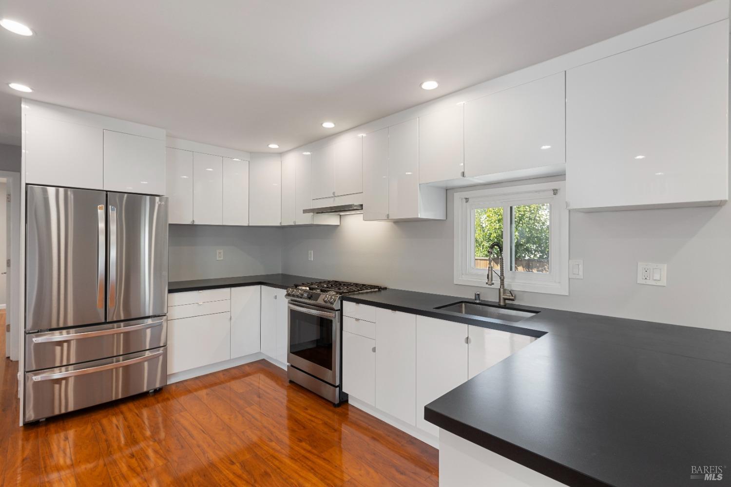 363 Glacier Way San Rafael, CA 94903 - Photo 5 of 20 a kitchen with stainless steel appliances granite countertop a sink a stove and a refrigerator