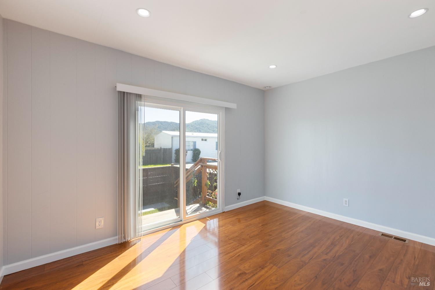 363 Glacier Way San Rafael, CA 94903 - Photo 6 of 20 a view of an empty room with wooden floor and a window