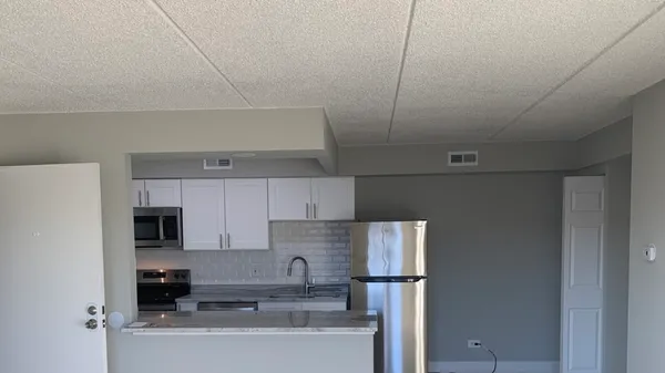 a kitchen with stainless steel appliances a refrigerator and cabinets