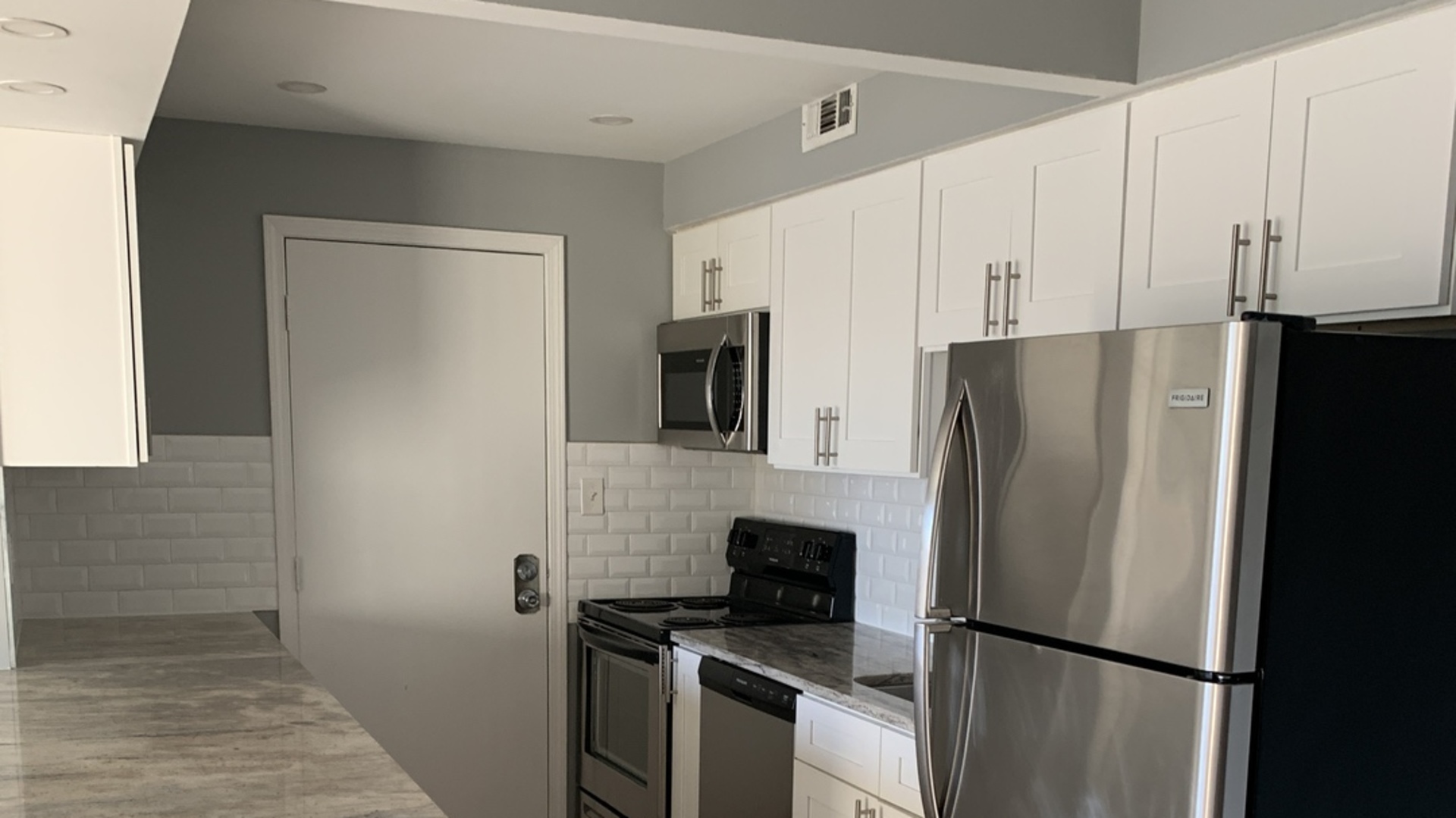 8141 84th Place, Unit 2D Justice, IL 60458 - Photo 5 of 19 a kitchen with a refrigerator stove and microwave