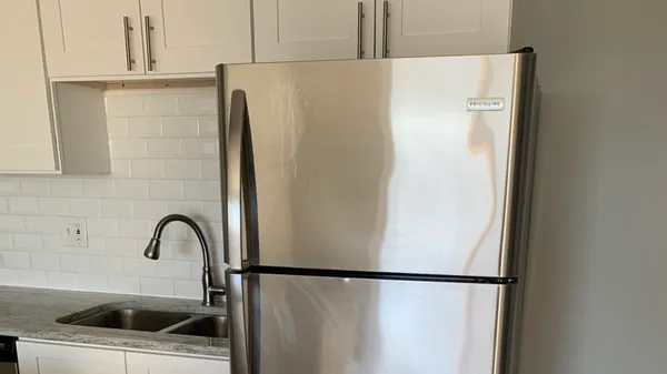 a close view of a sink and refrigerator