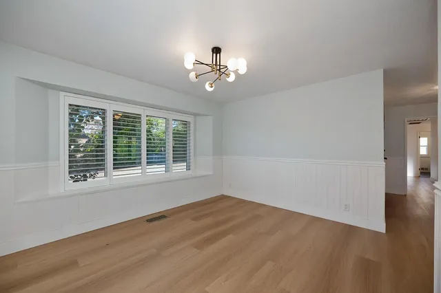 a kitchen with granite countertop a sink a counter space appliances and cabinets