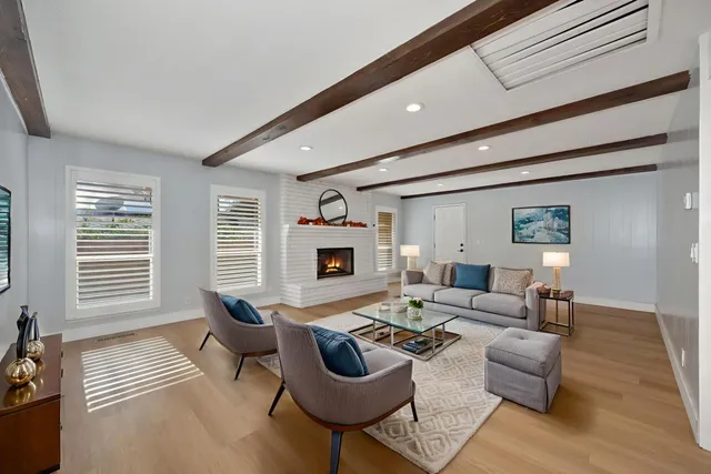 a view of empty room with wooden floor and fireplace
