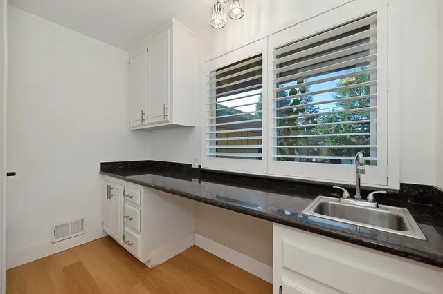 a bathroom with a sink a mirror and shower view