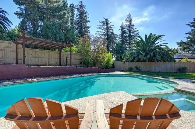 a view of a backyard with swimming pool