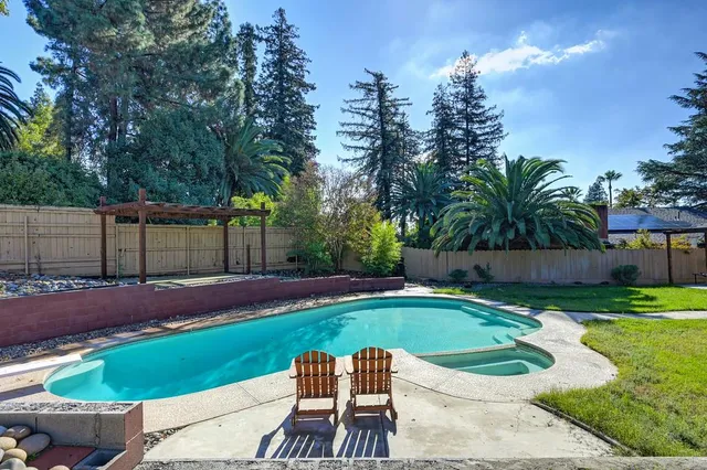 a view of a house with backyard porch and sitting area