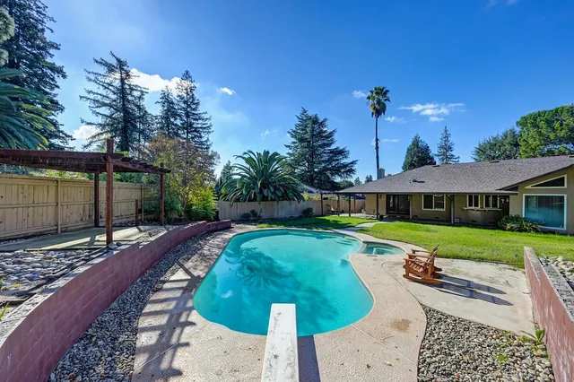a view of a house with a yard patio and a backyard