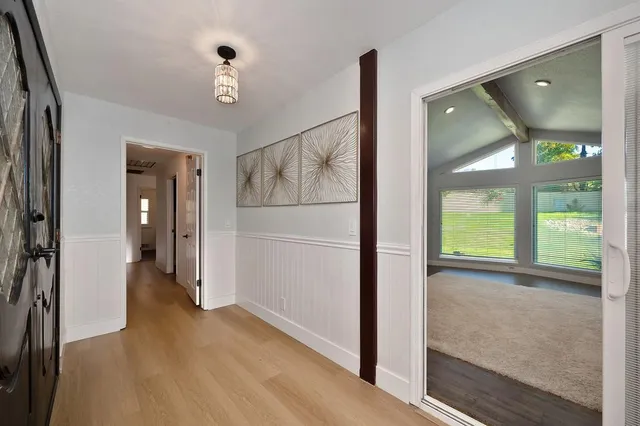 a living room with furniture and a table with garden view
