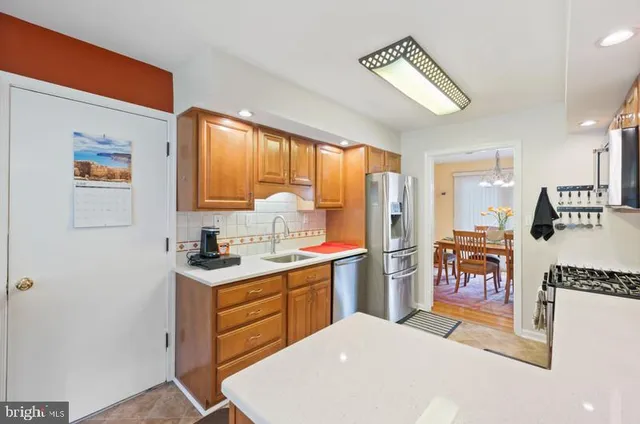 a kitchen with a refrigerator and a sink
