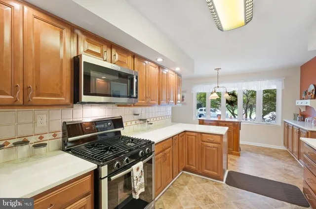a kitchen with a sink a stove and cabinets