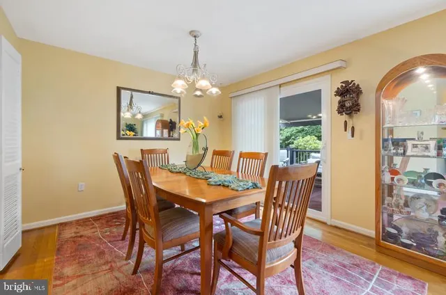 a view of a dining room with furniture and chandelier