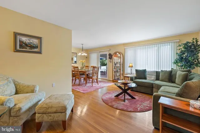 a living room with furniture a rug and a window