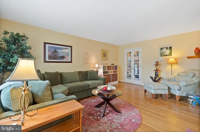 a living room with furniture and a lamp