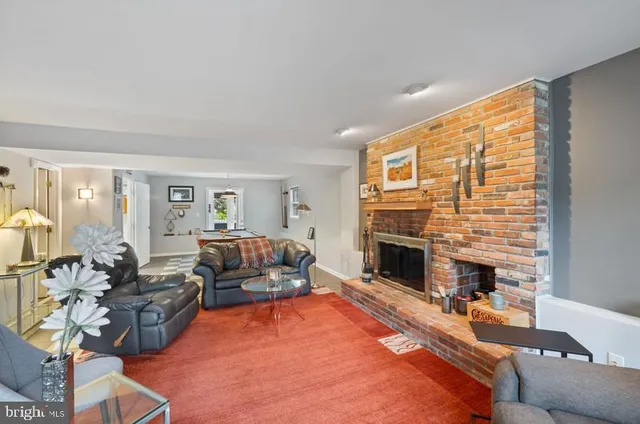 a living room with furniture fireplace and flat screen tv