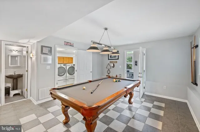 a room with pool table and mirrors