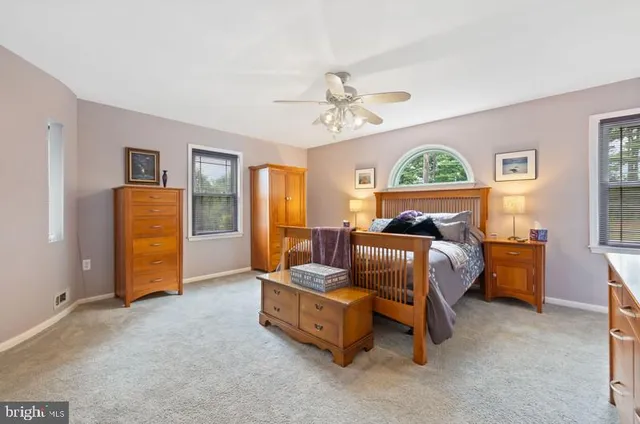 a bed room with a bed and a chair