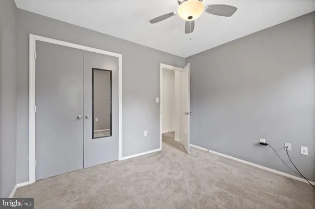a view of a livingroom with a chandelier fan