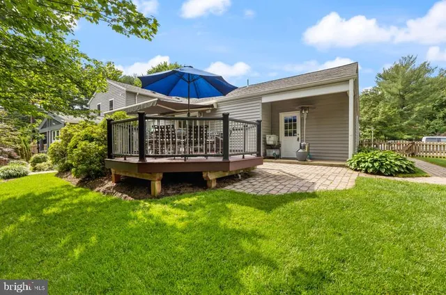 a view of a house with a yard and deck