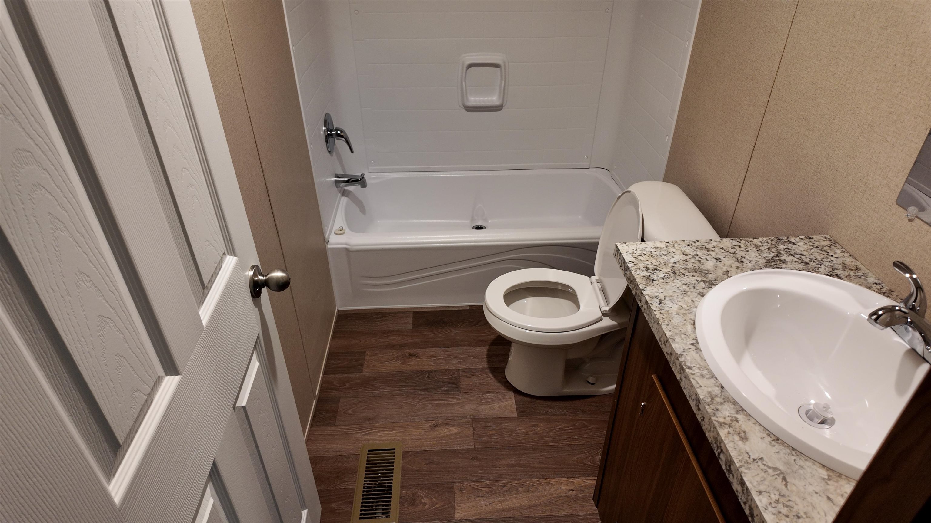 208 Marcy Cove Ripley, TN 38063 - Photo 9 of 14 Full bath with wood finished floors, vanity, and washtub / shower combination