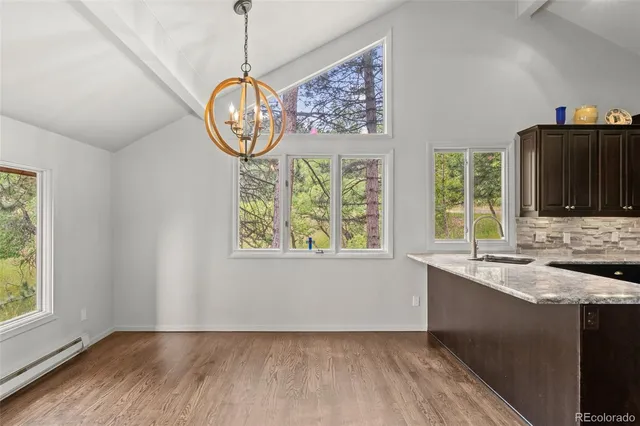 a view of an entryway with wooden floor and a window