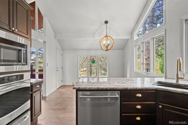 a kitchen with stainless steel appliances granite countertop a stove and a sink