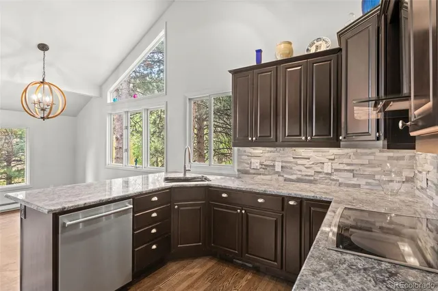 a kitchen with granite countertop a sink and a stove
