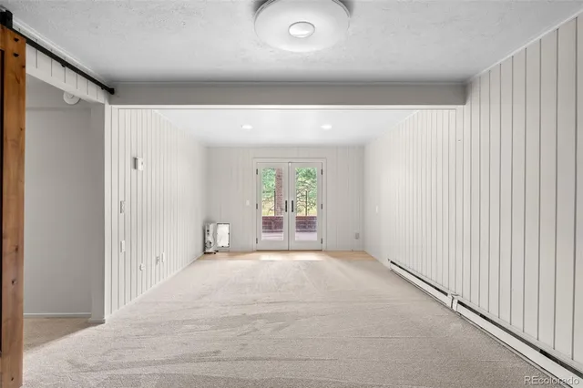 a view of a balcony with wooden floor and a bench