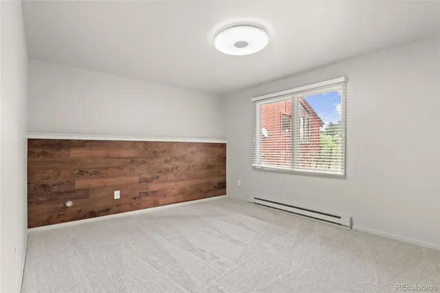 a bathroom with a granite countertop sink and a toilet