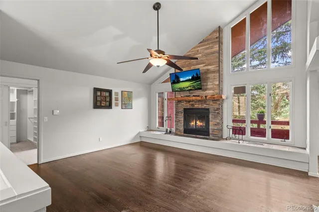 a view of a livingroom with a fireplace and window