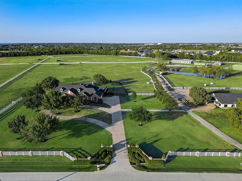 an aerial view of a houses with outdoor space and tennis court