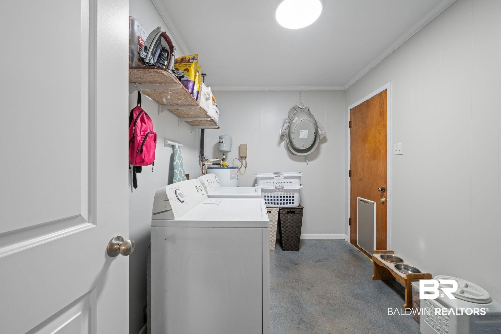 621 Ann Street Saraland, AL 36571 - Photo 14 of 21 Laundry room with crown molding and washer and dryer