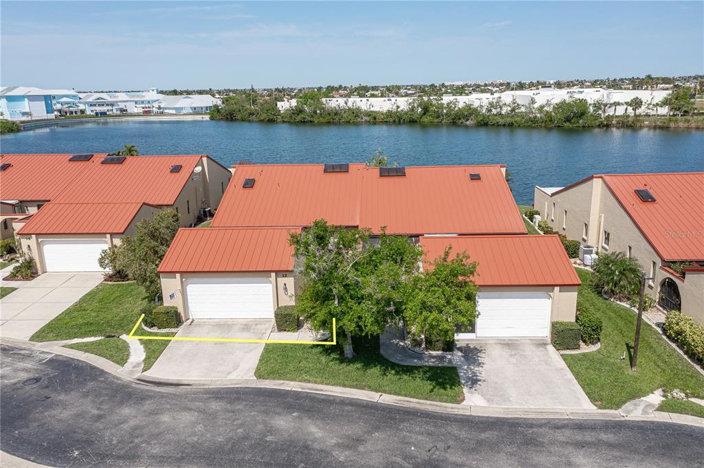 an aerial view of a house with outdoor space lake view and lake view