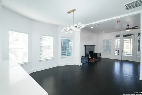 a view of a living room with fireplace and window