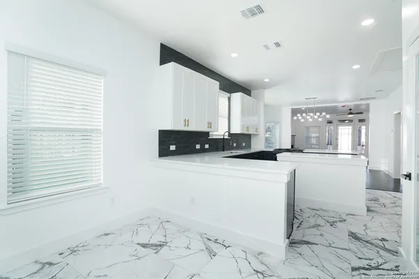a kitchen with stainless steel appliances cabinets a sink and a window