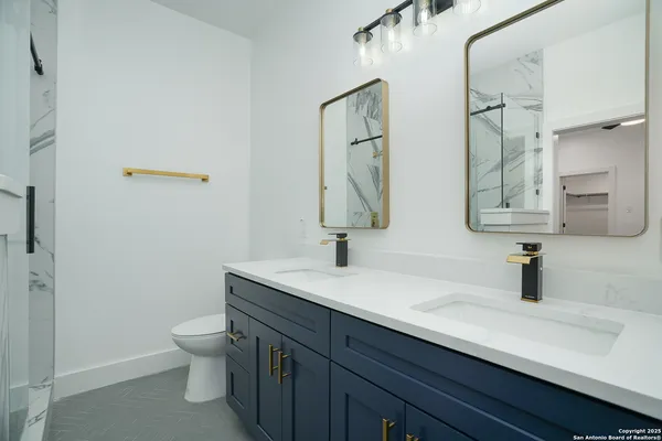 a bathroom with a toilet sink and mirror