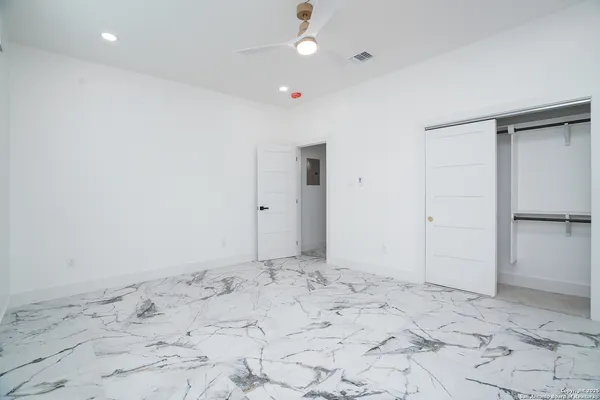 a view of a big room with wooden cabinet and refrigerator